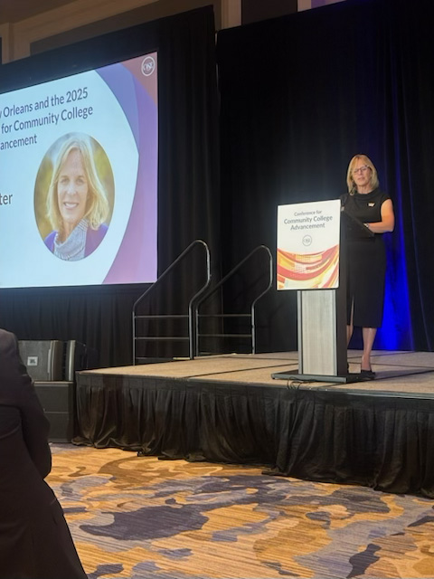 Meg Natter on stage speaking