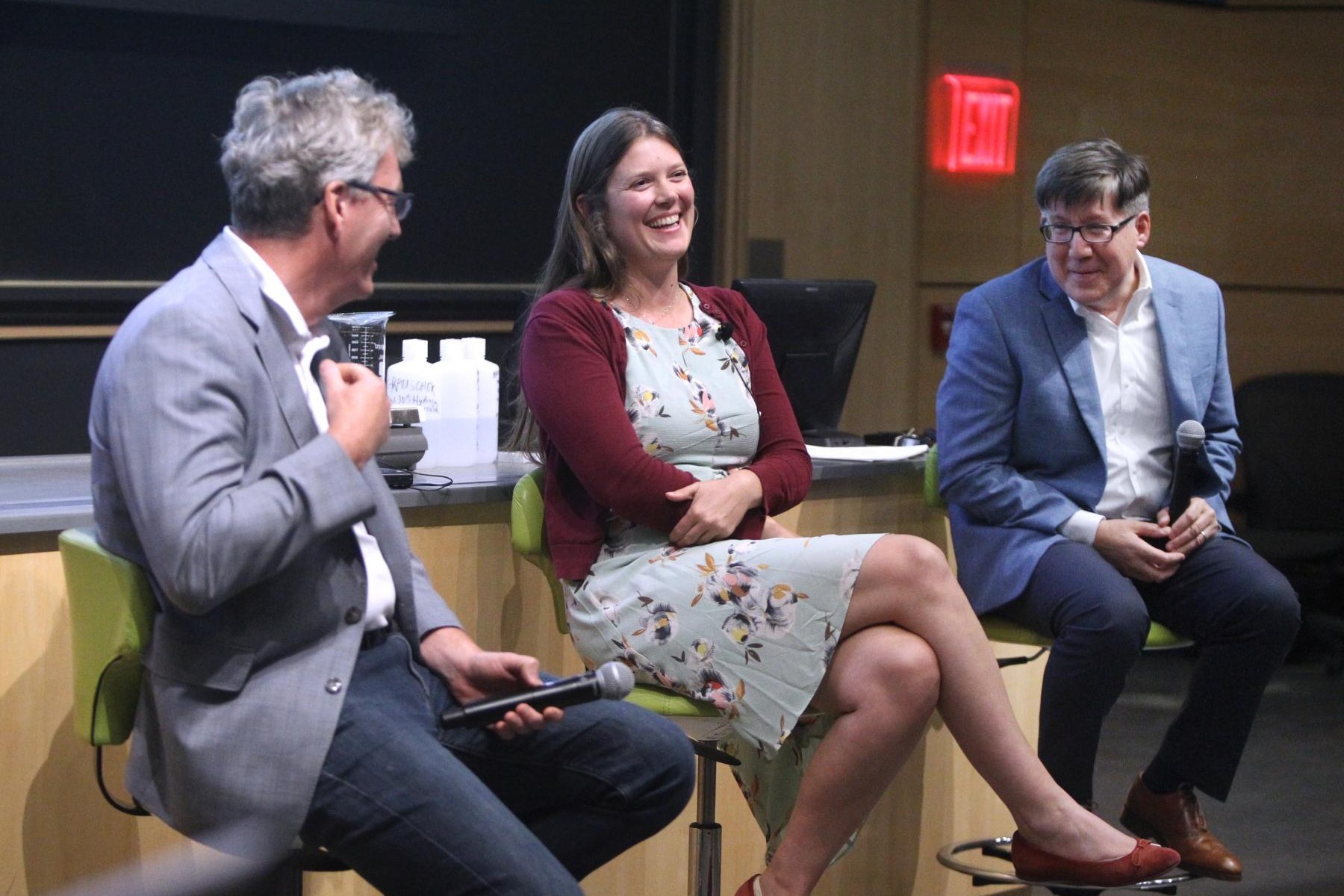 Leslie Schoop sits center on a panel with two other chemistry professors.