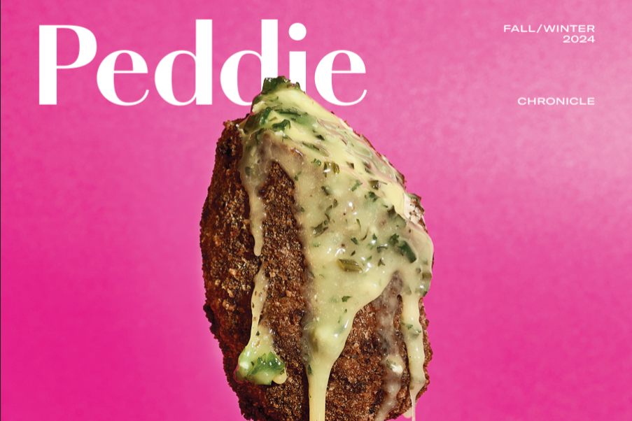 In front of the Peddie Chronicle masthead, is the photo of a piece of breaded chicken dripping in a yellow sauce with herbs in it against a pink background.