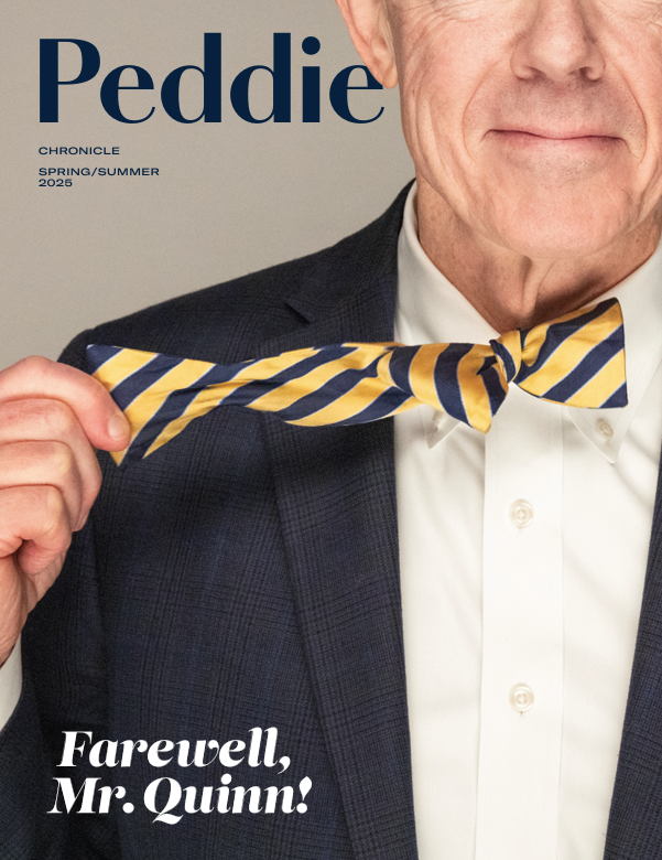 The cover of the Spring/Summer 2025 issue of the Peddie Chronicle features a close-up of Peter Quinn removing the blue and yellow striped bow tie at his collar with his right hand.