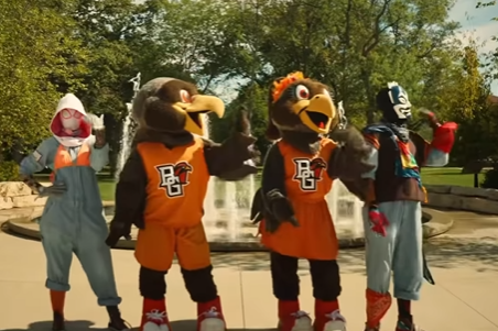 A screenshot from "Ranking Announcement Video." Four people dance in a line--two mascots at center and two other people dressed up as characters on either side.