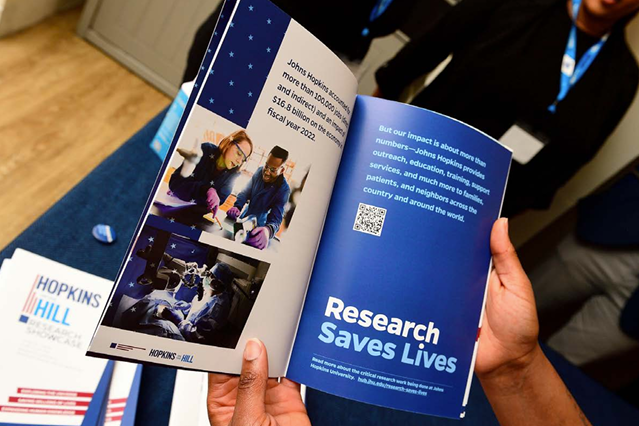 A photo of someone holding open a Research Saves Lives campaign booklet.