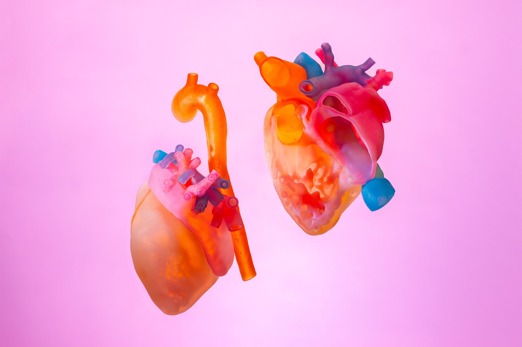 UCSF's 3D-printed models of hearts against a pink background.