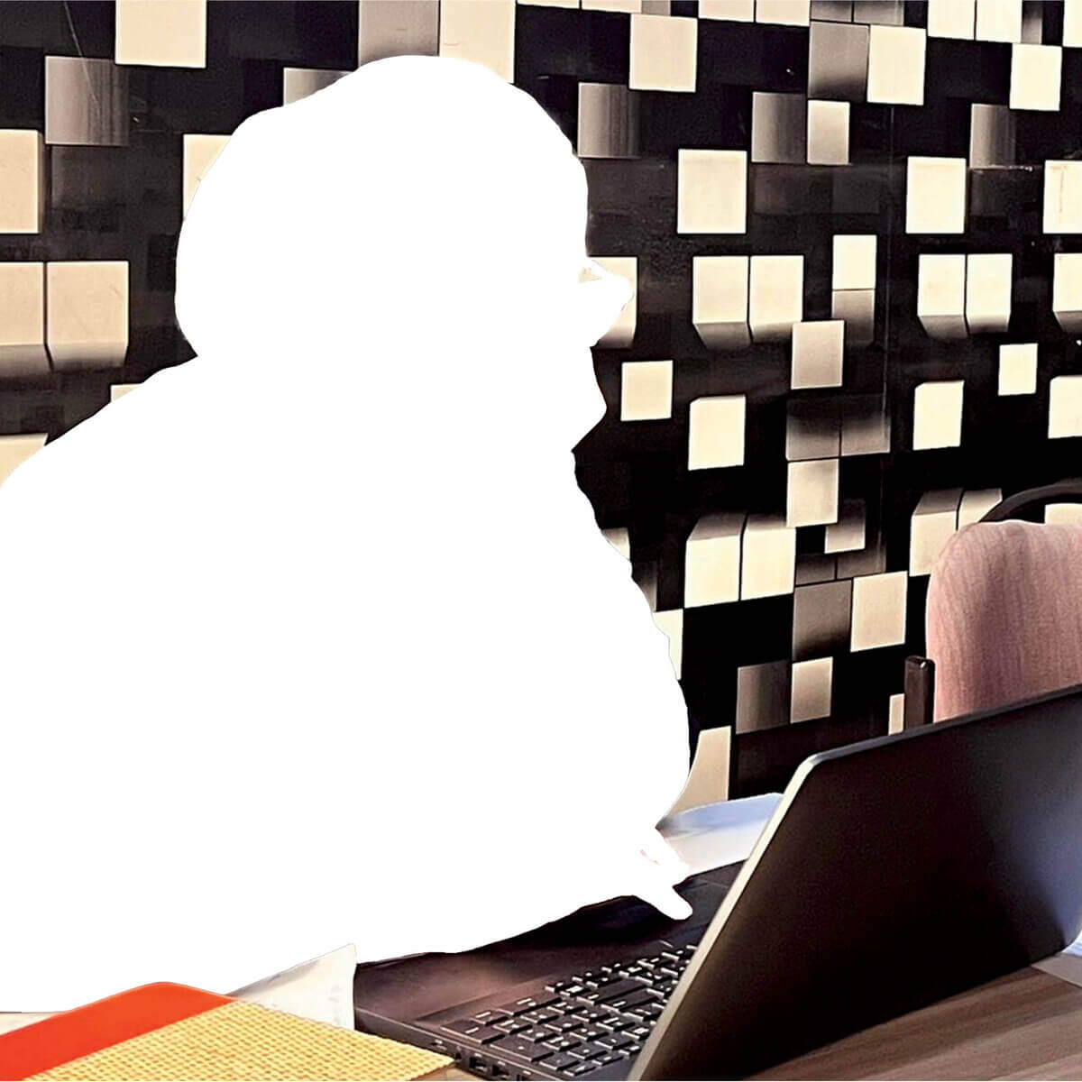 An illustration of a student working at a laptop. The shape of the student is entirely whited out.