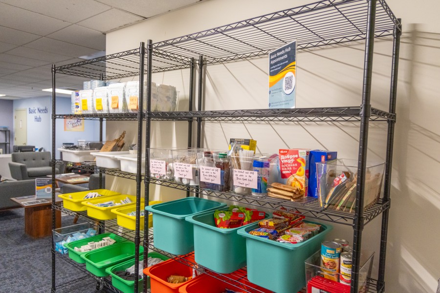 Bins of food, hygiene products, and emergency resources for students at the Basics Needs Hub