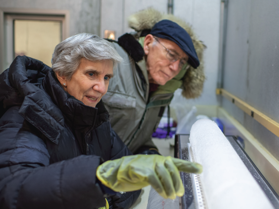 researchers examine an ice core