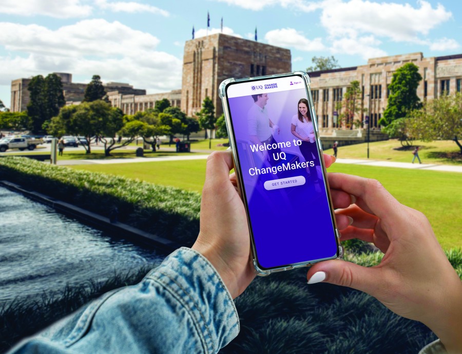 marketing image with a phone displaying the UQ ChangeMakers app in the foreground and a university landscape in the background