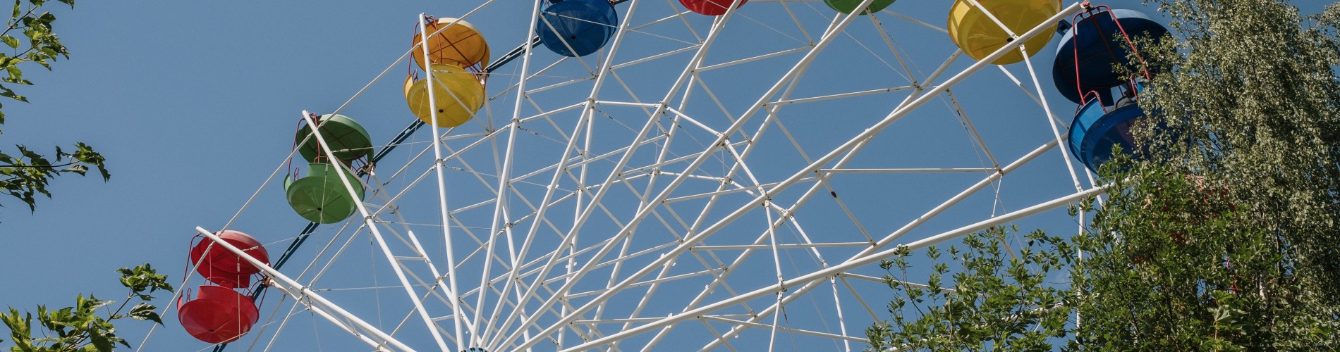 colorful Ferris wheel, against a blue sky