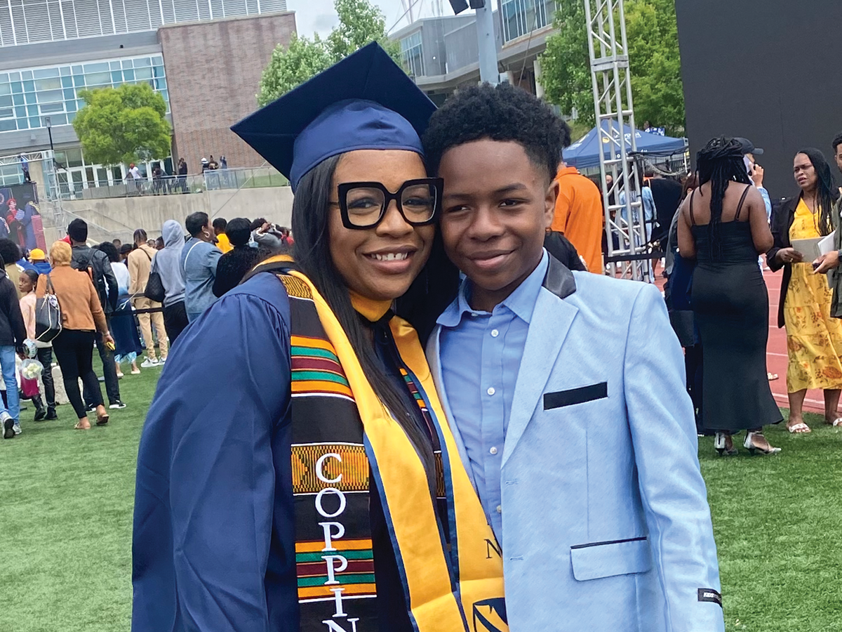 Nekia Randall in cap and gown with her son, after graduating from Coppin State University
