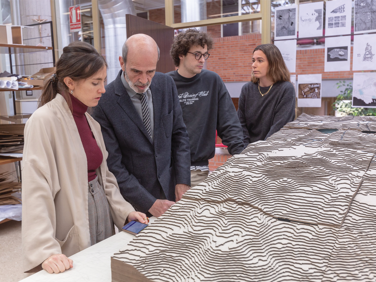 Students and faculty admiring three dimensional model at the University of Navarra School of Architecture
