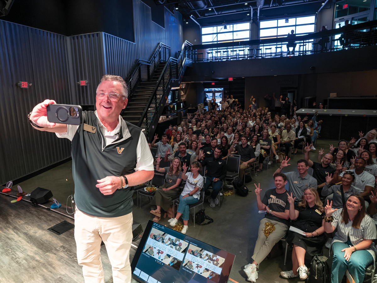 Vanderbilt Vice Chancellor for Development and Alumni Relations John M Lutz snaps a photo in front of large audience