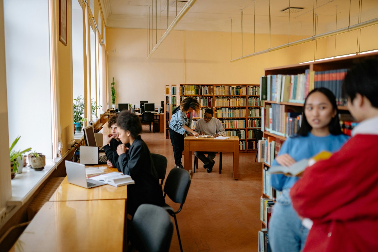 Students studying and talking in a university library