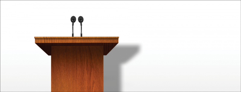 empty podium against a blank wall