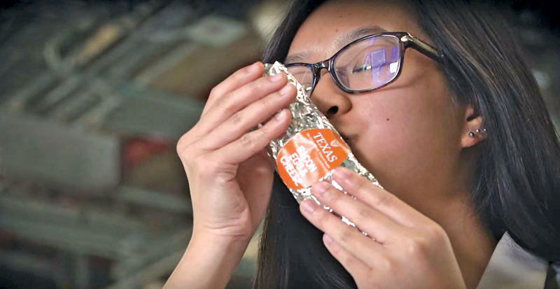 UT Austin Student kisses a breakfast taco