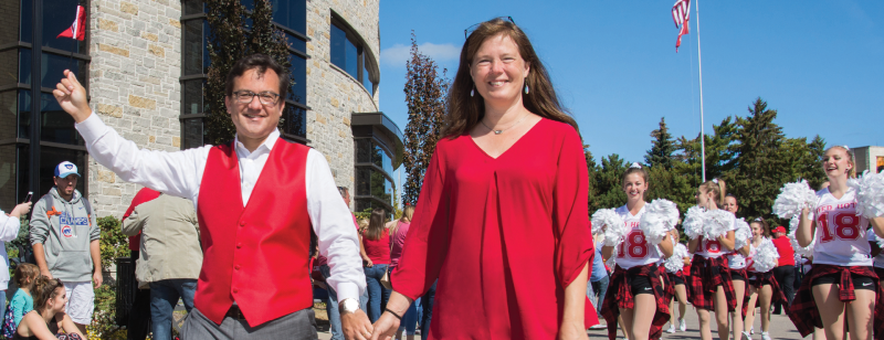 REASON TO CHEER: President John Swallow and his wife, Cameron, take part in their first Carthage College homecoming parade.