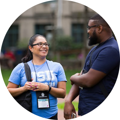 two people talking at a conference
