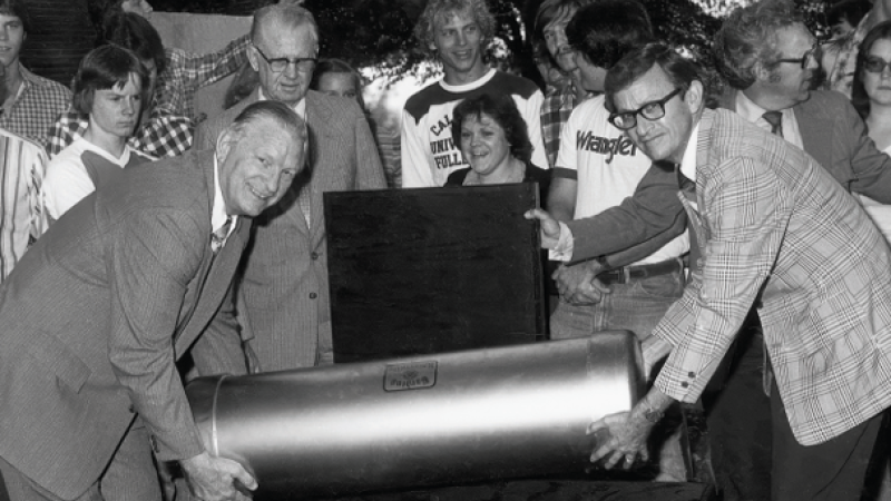 Black and white photo of Harding University President Clifton L. Ganus Jr. and Vice President for Finance Lott Tucker burying a time capsule in 1979.