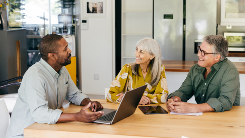 Three colleagues having a discussion at a table