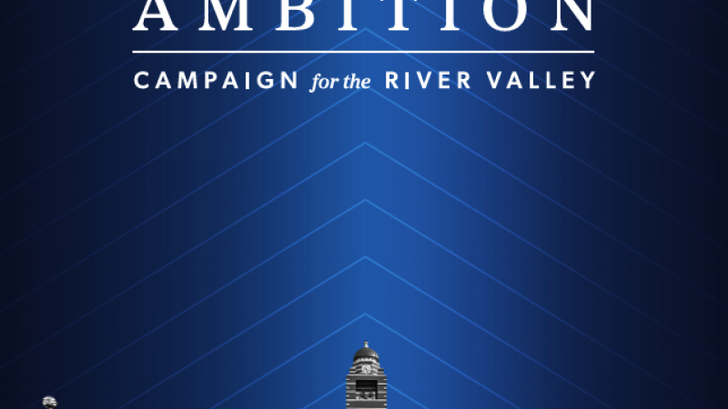 The cover of Intrepid Ambition features a dark blue background and a black and white photo of the University of Arkansas, Fort Smith campus.
