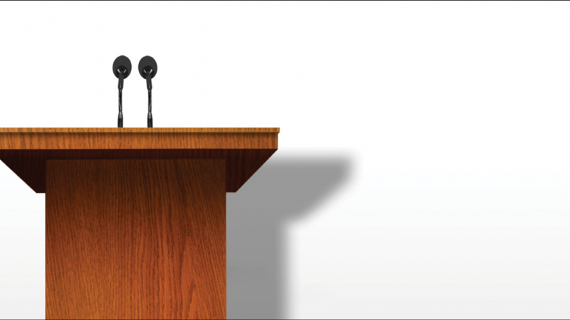 empty podium against a blank wall