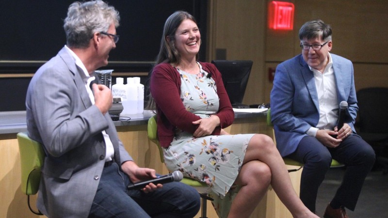 Leslie Schoop sits center on a panel with two other chemistry professors.