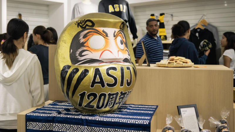 A photo of ASIJ's spirit store shows products and customers milling about inside.