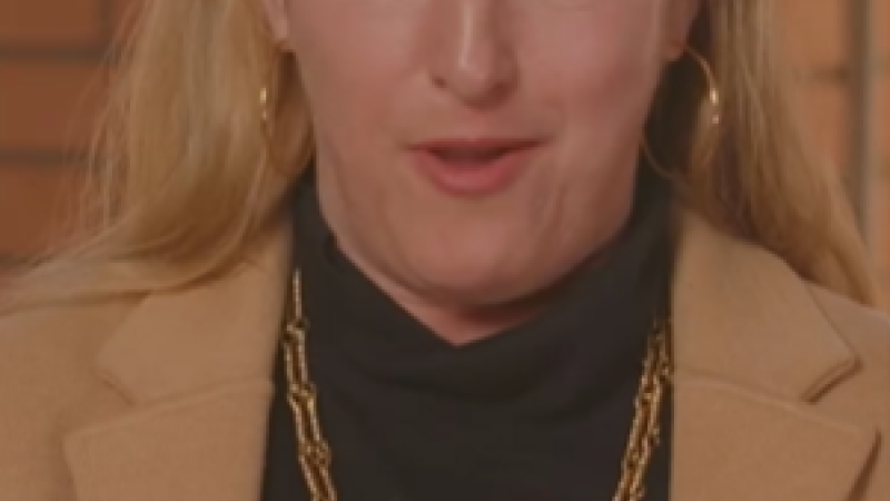 A screenshot from University of Southern California's "Professors Surprised With Student Reviews" video. A professor reads from a sheet of paper, "I hope she reads this and never quits her job."