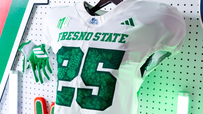 A photo of Fresno State's Ag Fest–themed football jerseys. The green numbers on the jerseys contain agriculture imagery in a dark green.