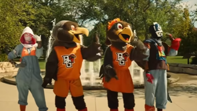 A screenshot from "Ranking Announcement Video." Four people dance in a line--two mascots at center and two other people dressed up as characters on either side.