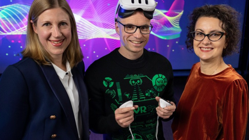 From left to right, Solange Glasser, Ben Loveridge (wearing an VR-set), and Margaret Osborne pose for a photo.