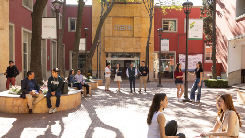 A photo of the ITAM campus. Students and professors spend time in a shaded courtyard.