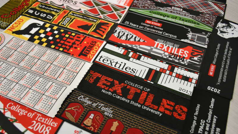 A photo of a series of North Carolina State University branded textile bookmarks.