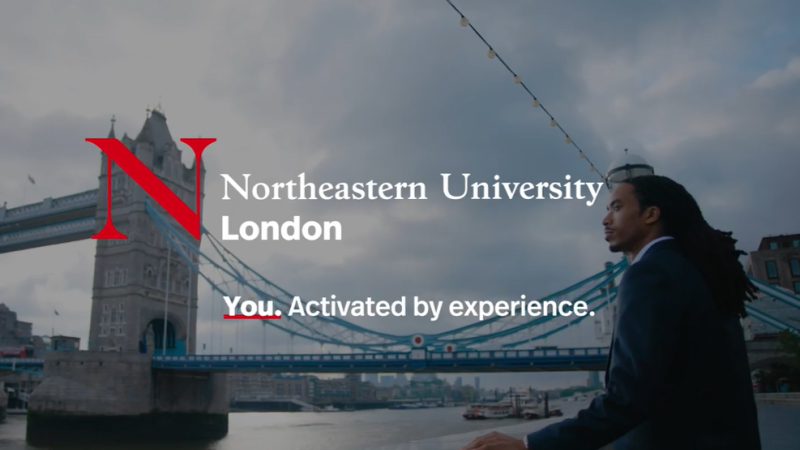 A man stands beside the Thames River, Tower Bridge in the background, with the words, "Northeastern University London: You. Activated by experience."