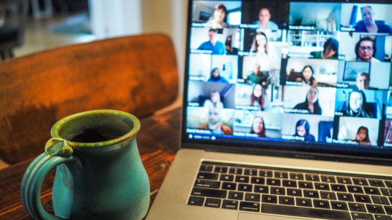 Mug on a desk in front of laptop during a video call